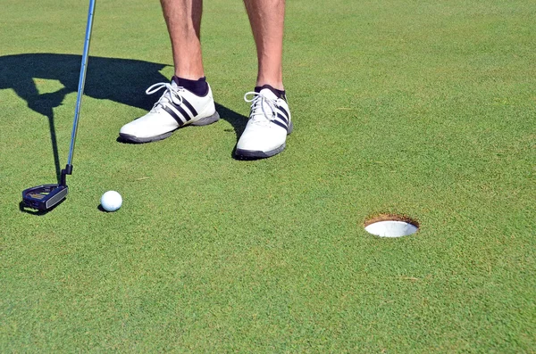 Golf ball golfschoenen en stok Stockafbeelding