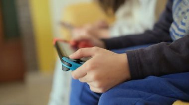 Preschooler Kids playing with portable videogames console,tech kids addiction