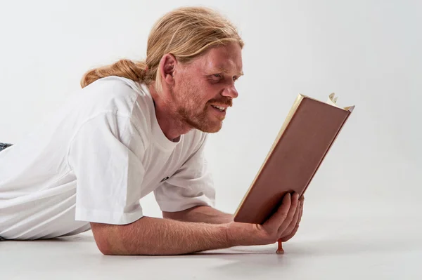 Lying man with book — Stock Photo, Image