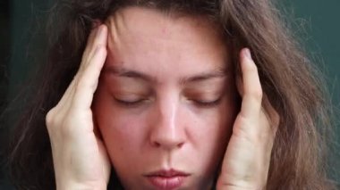 Kapalı kapılar ardında masaj yapan, başı ağrıyan, başı ağrıyan, migreni olan, kapalı gözleri olan, kapalı oturan genç bir kadın. Acı çekiyordu. Gerilim ve basınç kavramı Stresli hissediyorum.