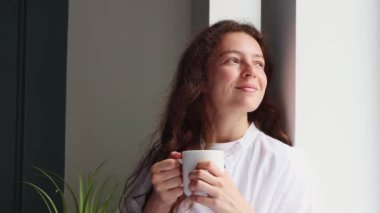 Güzel bir milenyum genç kadını pencereden dışarı bakıp seviniyor, arzuyu düşünüyor, planlar yapıyor, sabahları içilen kahveyi gözünde canlandırıyor. Kapalı mekanda dinleniyor, hafta sonunun tadını çıkarıyor..