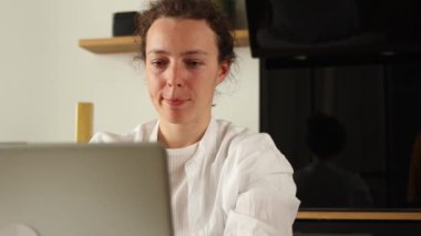 Smiling caucasian business woman or student finished computer work, stretching relaxing sitting at home workplace. Satisfied by project accomplishment, feeling stress relief, task done in time concept
