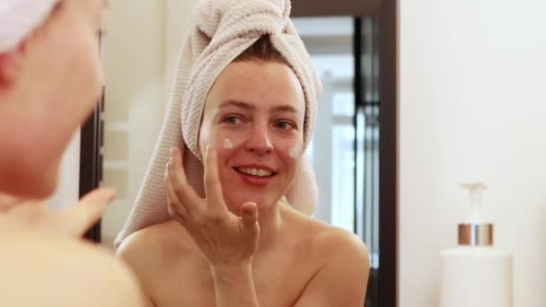 Happy Attractive Young Caucasian Woman Applying Skincare Cream Face Looking — Stockvideo