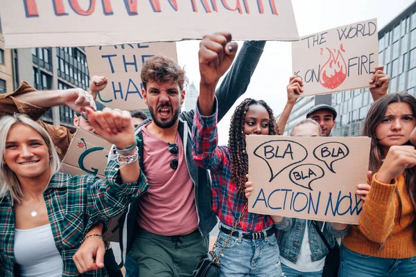 angry crowd on the street protesting for climate change - strike with banners for the global warming