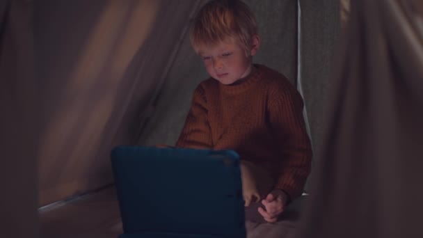 Caucasian Child Plays Using Tablet Tent — Αρχείο Βίντεο