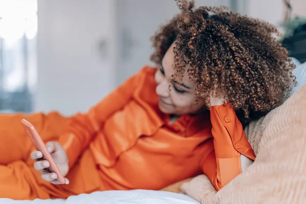 Elegant Curly Hair Woman Lying Bed Checking Mobile Phone Side — Fotografie, imagine de stoc