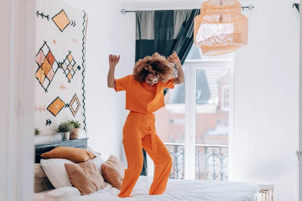 Happy Young Woman Orange Outfit Dancing Bed — Fotografie, imagine de stoc