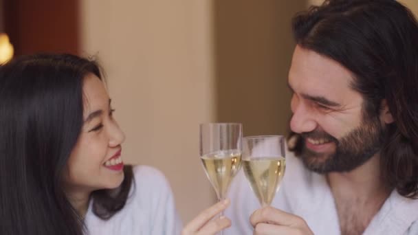 Happy Multi Ethnic Couple Bathrobe Cheering Flute White Wine Hotel — Stock Video