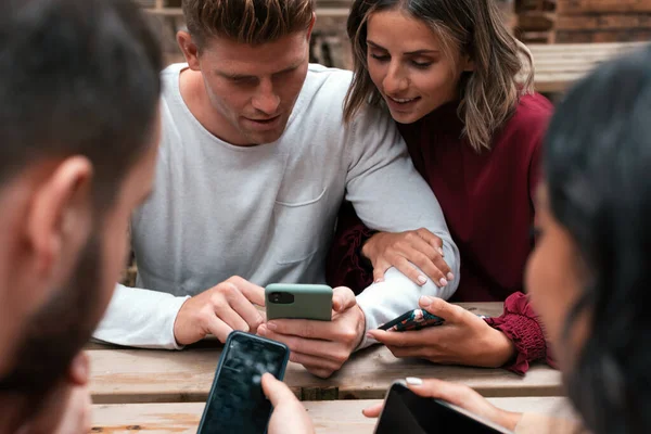 Friends Sitting Outdoors Holding Using Smartphones — Stock Photo, Image