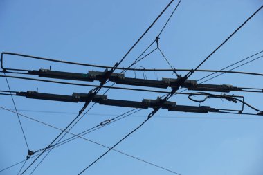 Bucharest, Romania - May 12, 2022: Power supply joint at the intersection of the wires of the electric power supply lines of the trams.