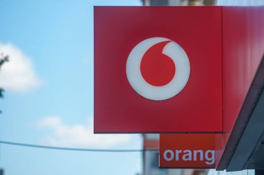 Bucharest, Romania - August 04, 2022: Logo of Orange, French telecommunications company and Vodafone, British telecommunications company is displayed on the top of a GSM shop in Bucharest, Romania.