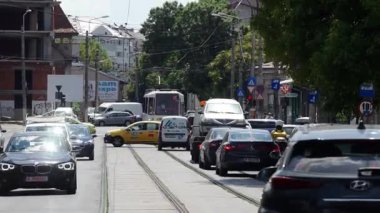 Bucharest, Romania - August 04, 2022: Cars in traffic at rush hour on a boulevard in Bucharest.
