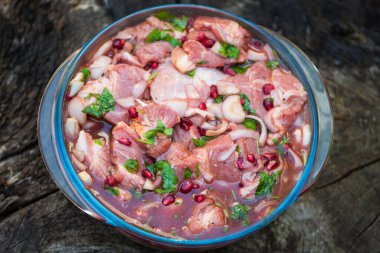 chopped pork neck in pomegranate marinade with onion and parsley, spices, for barbecue