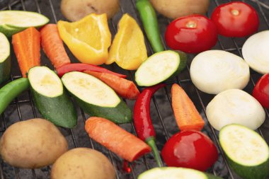different fresh vegetables are cooked on the grill, barbecue