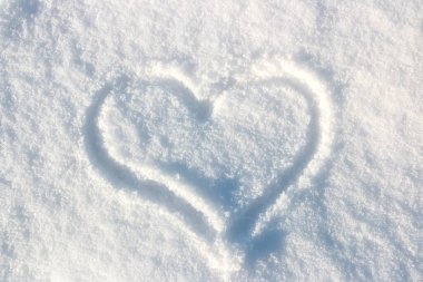 Frozen heart painted on white snow background