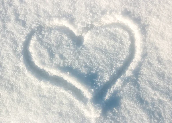 Frozen heart painted on white snow background