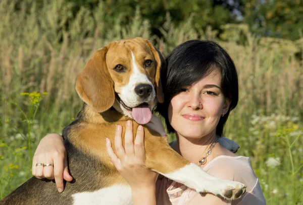 Girl with a dog in the park — Stock Photo, Image