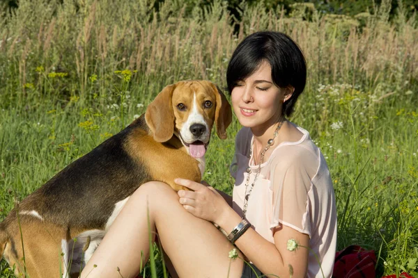 Girl with a dog in the park — Stock Photo, Image