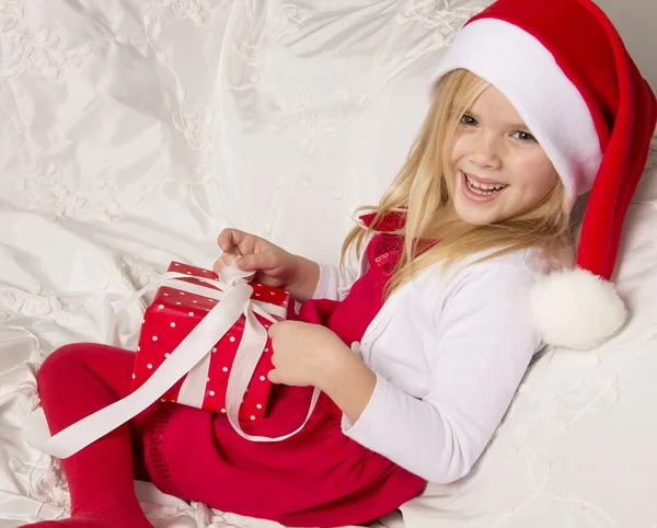 Girl opening Christmas gift — Stock Photo, Image