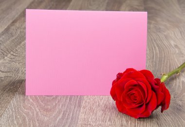 yanında kırmızı bir gül pembe kart