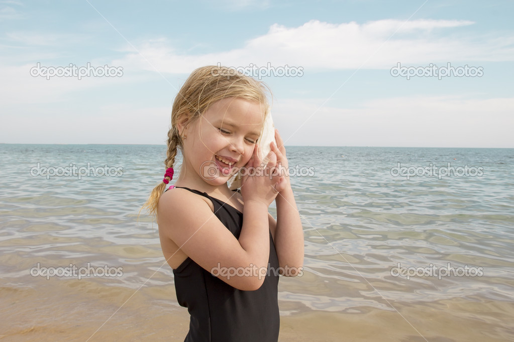 Girl With Shell Listening To The Sea Stock Photo By C Lomakivskatanya Girl With Shell Listening To The Sea Stock Photo By C Lomakivskatanya