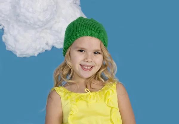 Beautiful smiling girl in a green cap — Stock Photo, Image