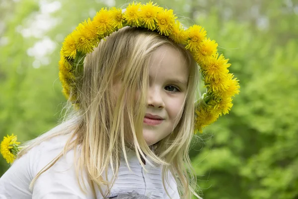 Girl in a wreath of flowers — Stock Photo, Image