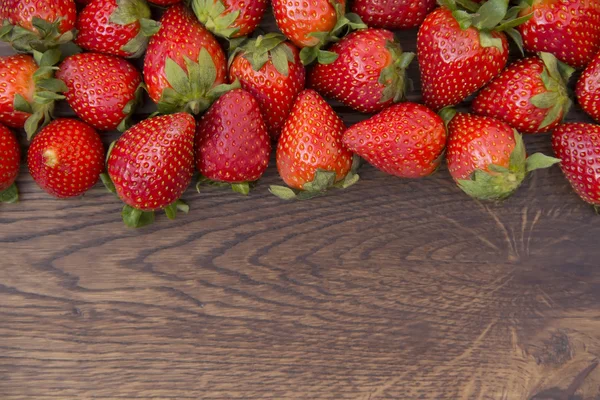 Strawberry spread on brown wooden surface — Stock Photo, Image