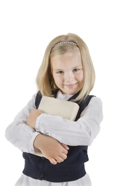 Girl schoolgirl holding book and smiling — Stock Photo, Image
