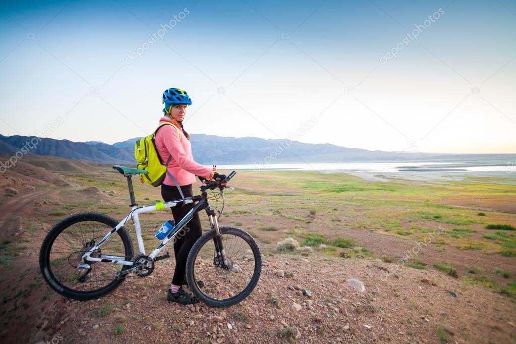 girl on a bicycle in the mountains
