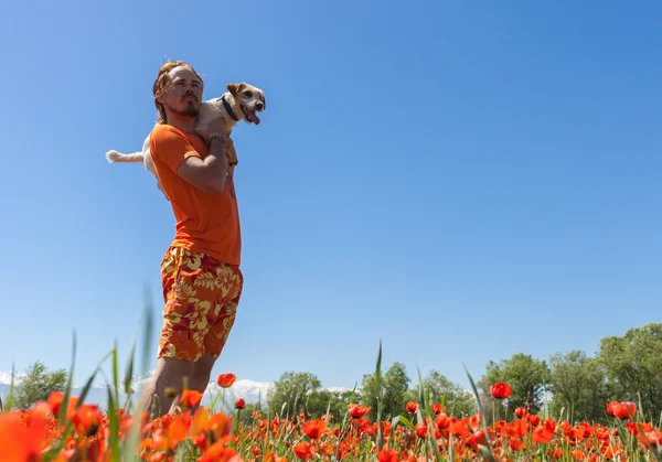 Man running on blooming poppies field — Stock Photo, Image