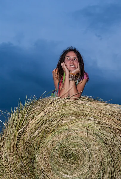 Girl jumping on a hay field — Stock Photo, Image