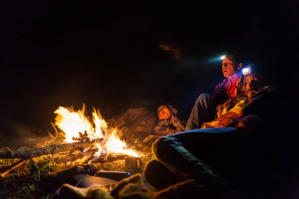 Bonfire in a camp in the mountains and the light of flashlights Royalty Free Stock Images