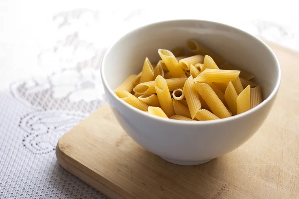 Uncooked penne pasta — Stock Photo, Image