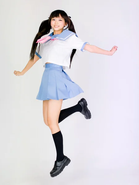 日本スタイルの学生の女の子をジャンプ アジア コスプレ ロリータ ストック画像