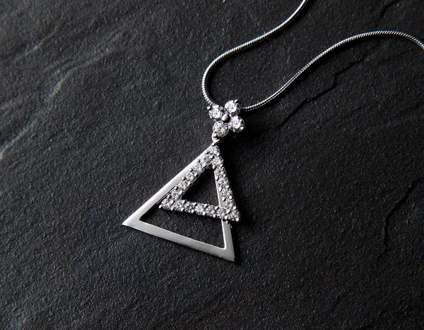 Jewelry triangle pendant with chain — Stock Photo, Image