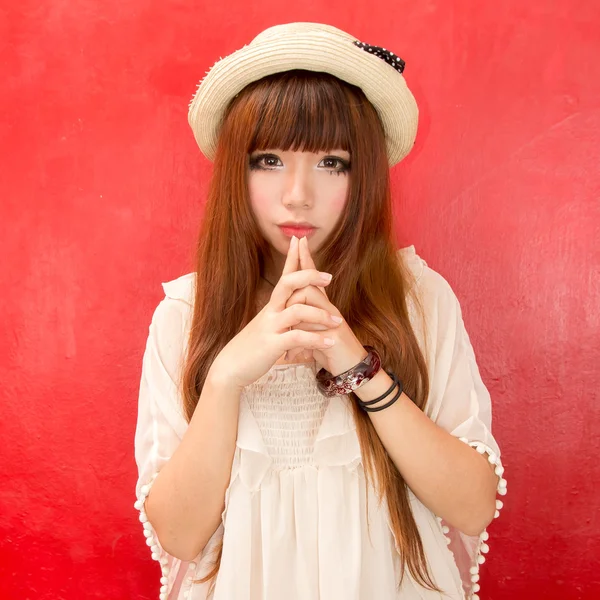 Asian girl over a red background — Stock Photo, Image
