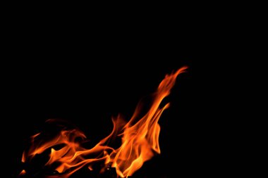 Grafik tasarımı ya da duvar kağıdı için yanan alevleri siyah arkaplanda kapat. Kırmızı ve sarı, ısı enerjisi gece boyunca yakıtı ateşliyor. Yemek pişirmek için kullanılan soyut ateş..
