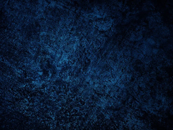 Dark rough cement wall background for graphic design or wallpaper. Grungy black and blue concrete texture in vintage style. The old plaster floor has a mysterious and terrifying age.