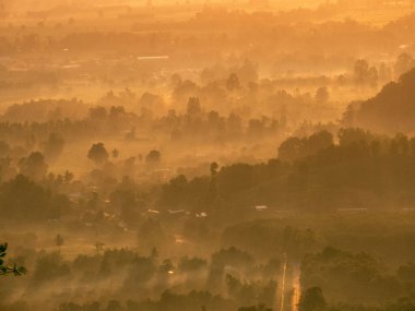 Amazing Sunrise Over Misty Landscape. Scenic View Of Foggy Morning Sky With Rising Sun Above Misty Forest