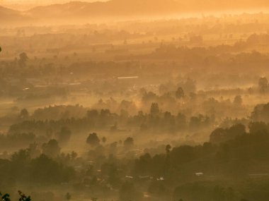 Amazing Sunrise Over Misty Landscape. Scenic View Of Foggy Morning Sky With Rising Sun Above Misty Forest