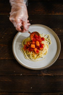 Sea products pasta with pepper and cheese Parmesan and sauce and tomatoes 