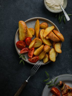 Pizza potato fries tomatoes chicken with sauces dark mood