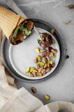 Pistachios ice-cream with pistachios nuts on ceramic plates with chocolate eggs 