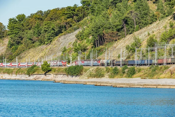 Los trenes de pasajeros y mercancías se mueven a lo largo de la costa del Mar Negro. Sochi.. — Foto de Stock