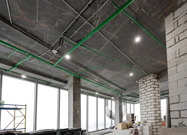 Construction work on the interior decoration of a modern office or apartment. Interior empty office light room in a new building renovation or under construction.