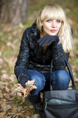 Girl on walk on the autumn wood clipart