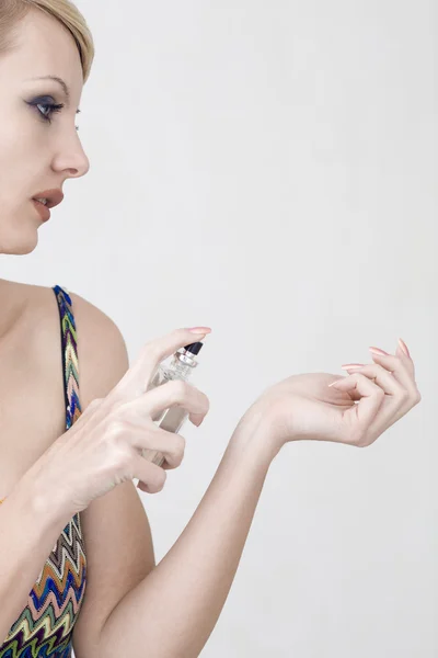 Young beautiful woman with perfume — Stock Photo, Image