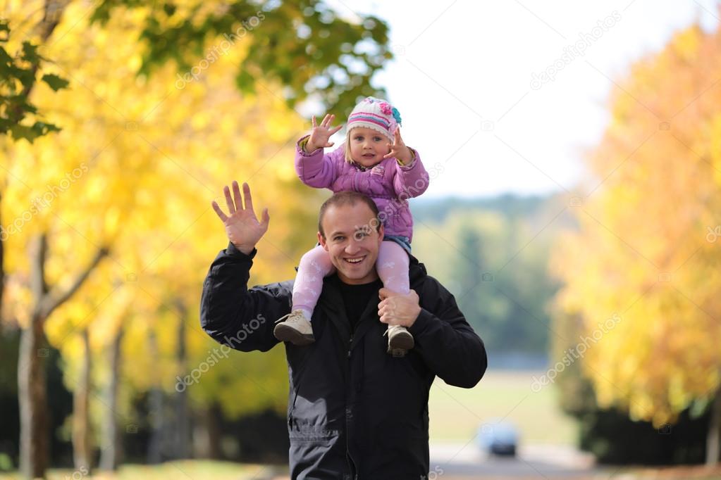 Happy father with the child walks in park