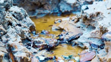 Water stream or stream in the sand close-up.
